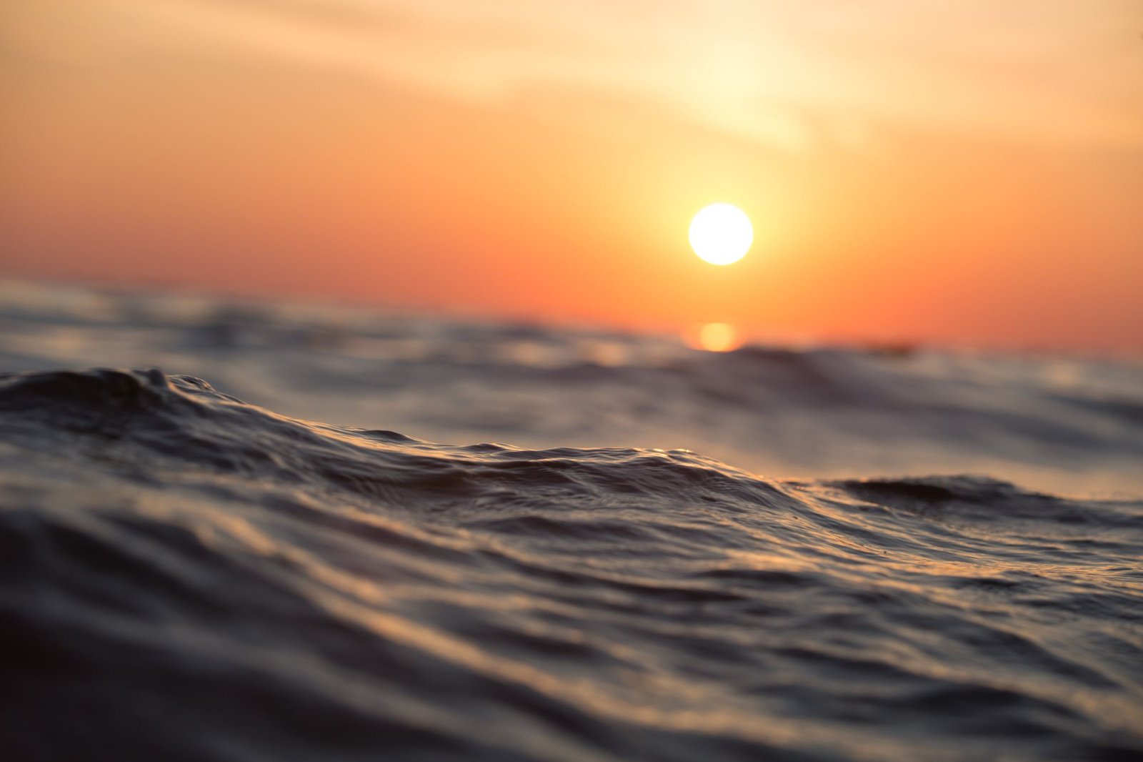 Sun setting over rippled coastal water